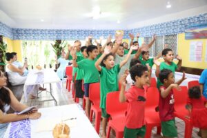 Children of Piu Scholars (a homework centre in Samoa) singing and doing action songs in the fale